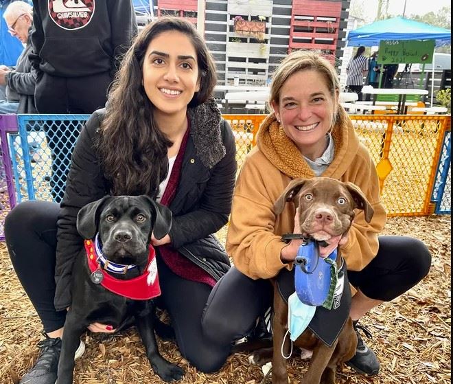 two women holding puppies